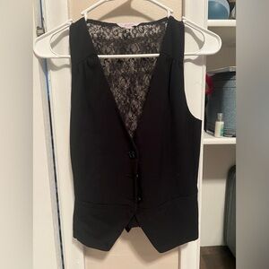 Super cute black vest with lace details.